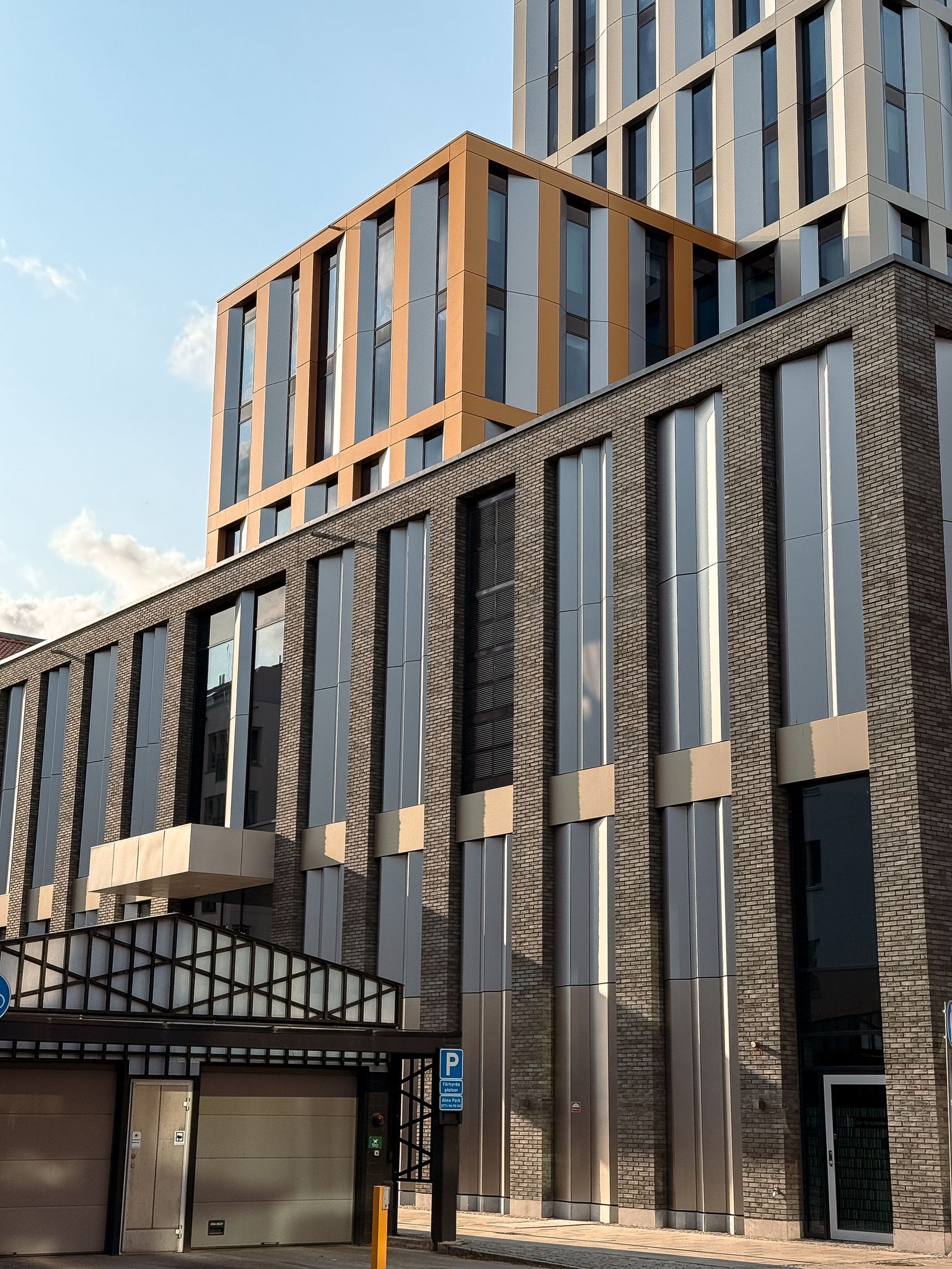 Contemporary building with sleek glass facade reflecting daylight.